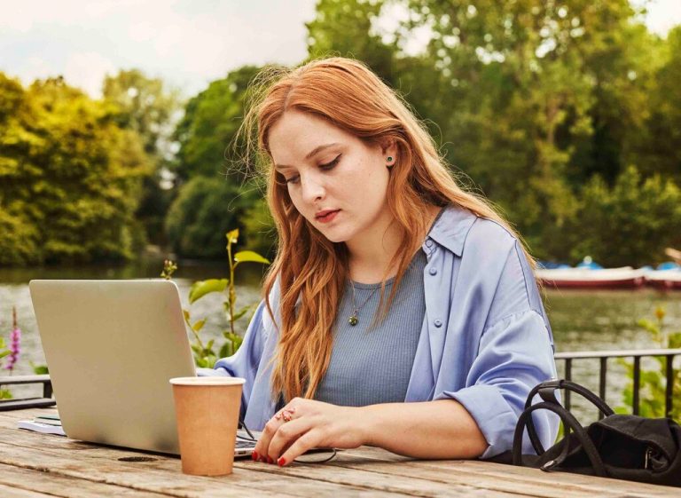 millennial woman with red hair working on LIO Sales training course