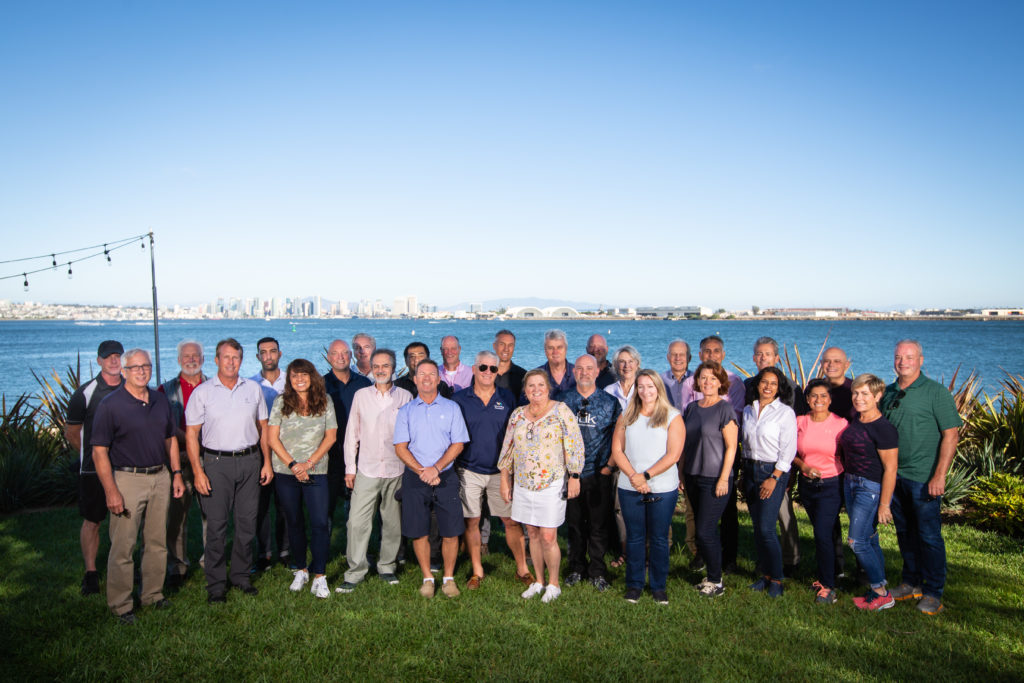 top sales trainers gather at company event by the water